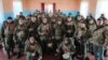 Российский глава Крыма Сергей Аксенов (в центре) с российскими военными, 20 февраля 2023 года