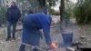 Ukraine - civilians with no access to gas or electricity build a fire in Kostyantynivka - screen grab