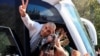 A freed Palestinian prisoner gestures in a bus after being released from an Israeli jail as part of a hostages-prisoners swap and a ceasefire deal in Gaza between Hamas and Israel.