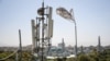 A Taliban flag flutters near telecom equipment installed over a rooftop providing Internet services overlooking Hazrat-e-Ali Shrine, or Blue Mosque, in Mazar-i-Sharif.