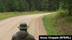 A Russian border guard looks towards his Estonian counterpart inside the "Saatse Boot" section of the two countries' shared border. 