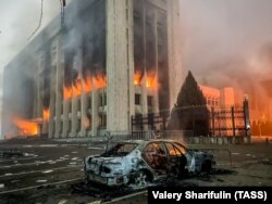 The Almaty mayor's office burns after being set ablaze by an angry mob over Kazakhstan's rising fuel prices on January 5.
