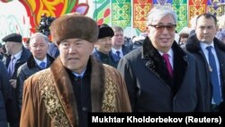 Kazakh President Qasym-Zhomart Toqaev (right) walks with former President Nursultan Nazarbaev in 2019. Toqaev has chosen to micromanage the upcoming election just as Nazarbaev used to, say observers, instead of proving his commitment to democratization.